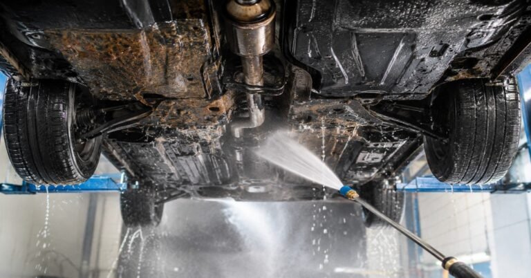 Professional technician performing high pressure undercarriage wash Buffalo NY to remove road salt and rust